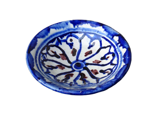 Small vintage ceramic dish with a blue glaze pattern with flecks of red. Moroccan earthenware dish with a hand-painted design.