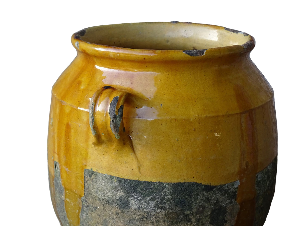 French antique confit pot with mustard yellow glaze. Terracotta jar with two handles.