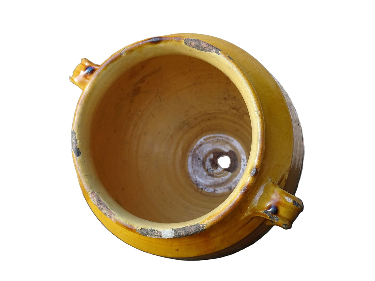 French antique confit pot with mustard yellow glaze. Terracotta jar with two handles.