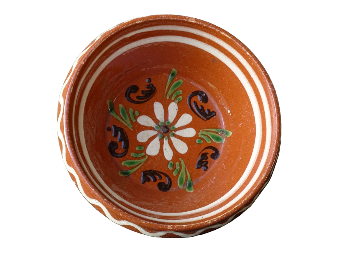 French vintage pottery bowl from Alsace. Glazed terracotta dish with painted flowers.