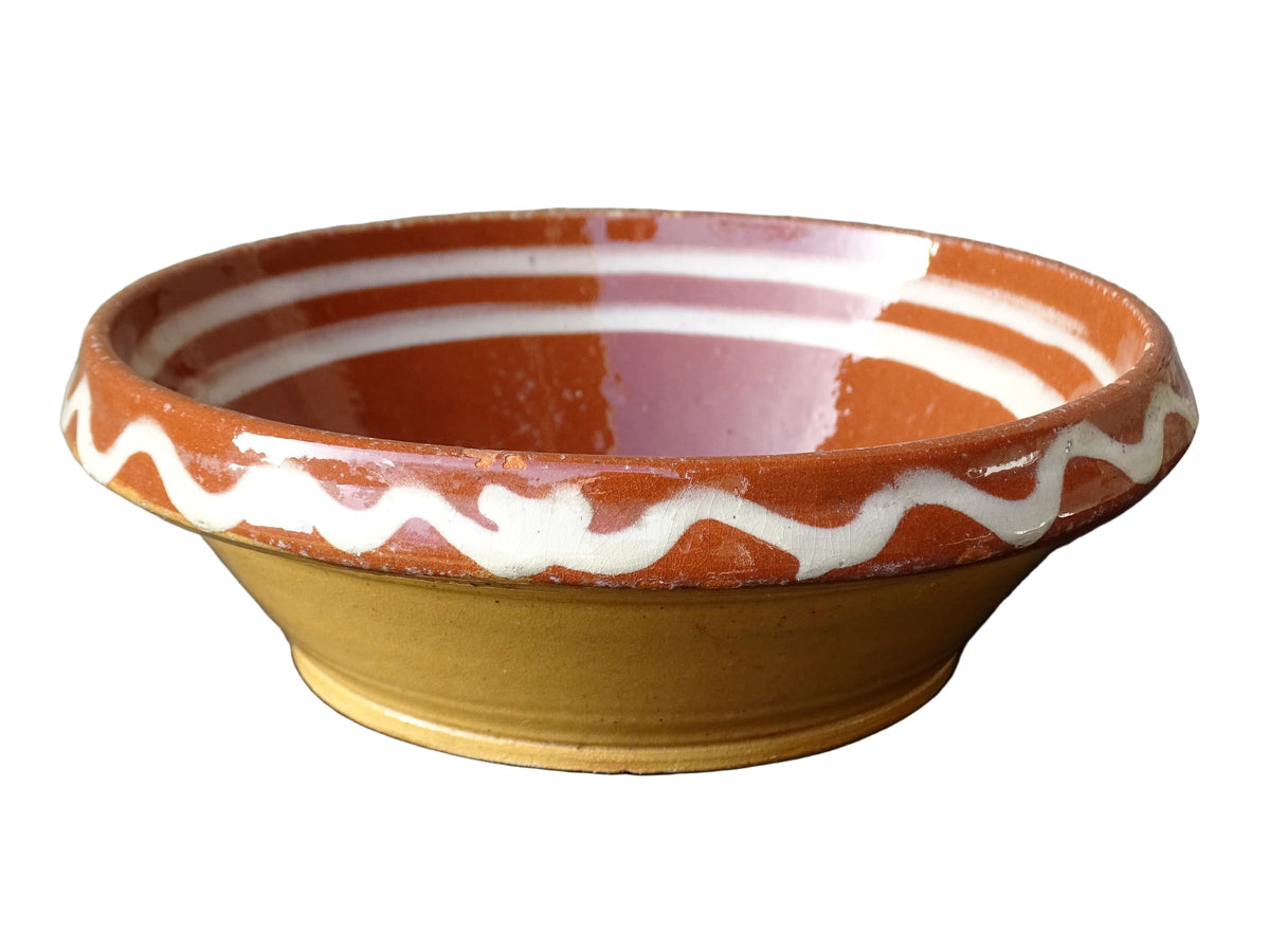 French vintage pottery bowl from Alsace. Glazed terracotta dish with painted flowers.