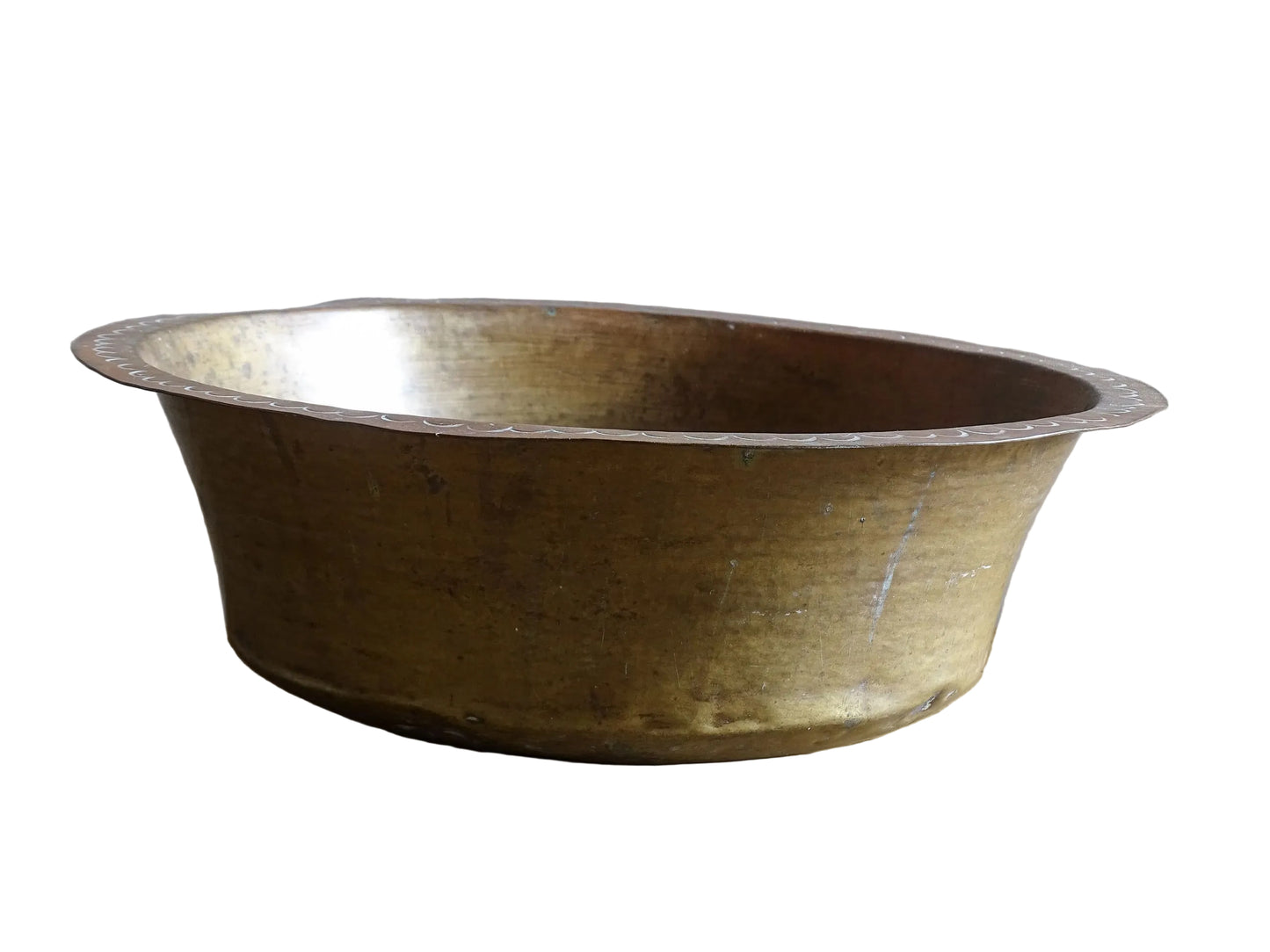 A timeworn French antique copper bowl with hammered detailing to the rim and a rounded base. This copper bowl has a beautiful, aged patina.