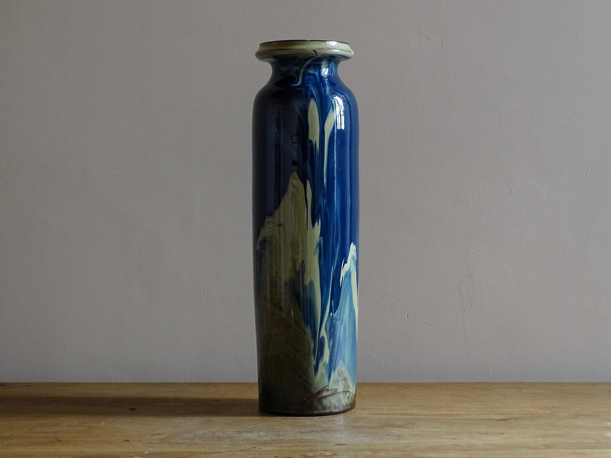 Vintage ceramic vase with a blue and cream glaze. Tall glazed terracotta vase, signed.