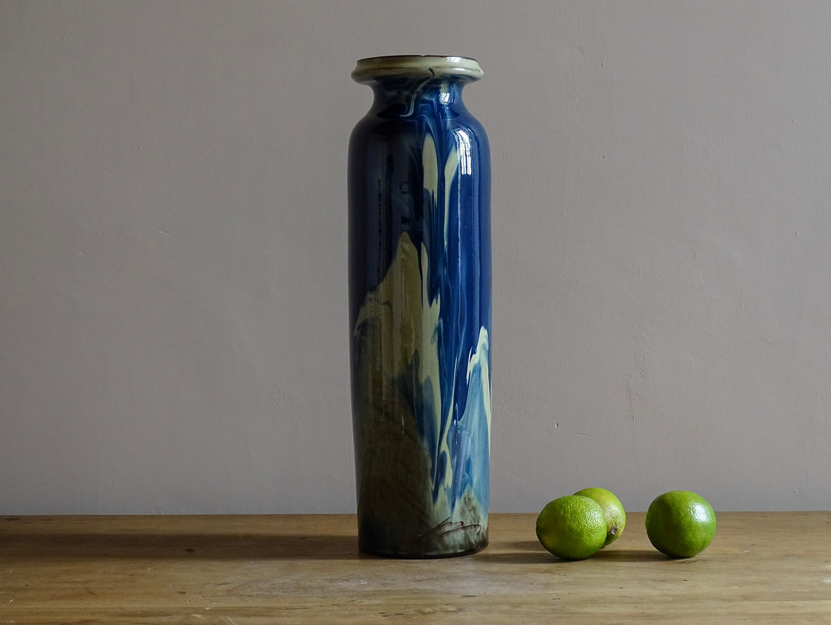 Vintage ceramic vase with a blue and cream glaze. Tall glazed terracotta vase, signed.