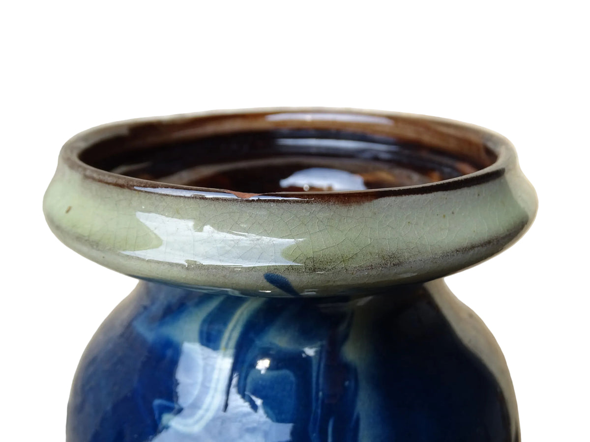 Vintage ceramic vase with a blue and cream glaze. Tall glazed terracotta vase, signed.
