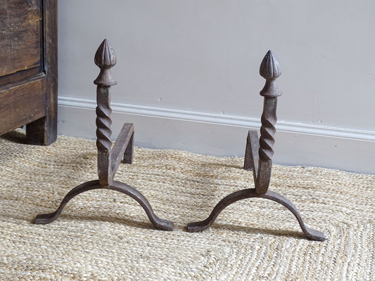 andirons or firedogs. They date to the 19th century. They are beautifully aged and have acorn finials and barley twist detailing.