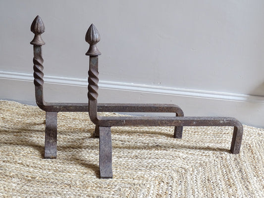 andirons or firedogs. They date to the 19th century. They are beautifully aged and have acorn finials and barley twist detailing.