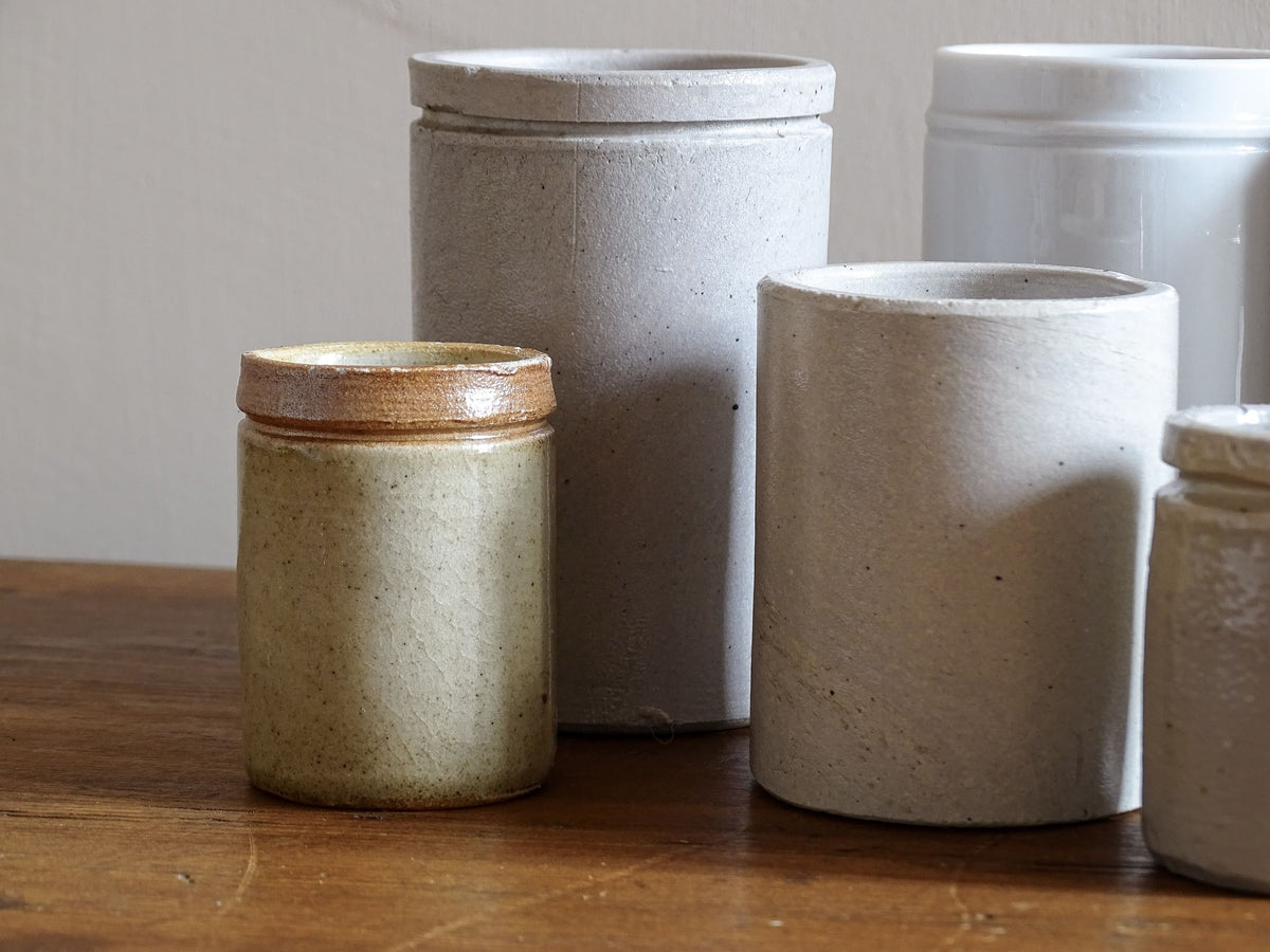 A set of seven small French vintage stoneware pots. This collection of pottery jars would look amazing as part of a rustic French farmhouse style home. Display in your kitchen as part of your shelf decor.