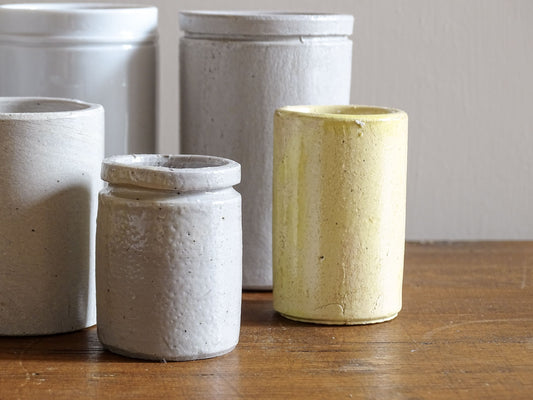 A set of seven small French vintage stoneware pots. This collection of pottery jars would look amazing as part of a rustic French farmhouse style home. Display in your kitchen as part of your shelf decor.