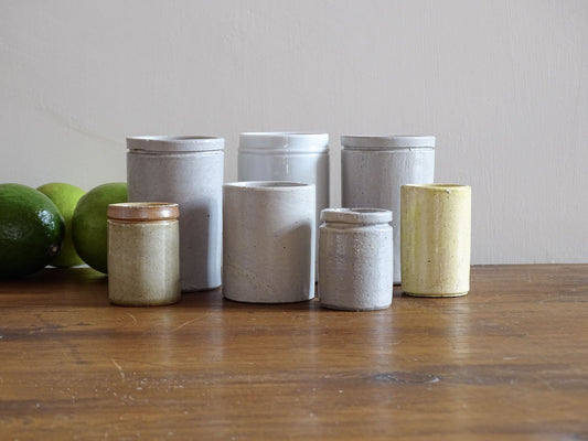 A set of seven small French vintage stoneware pots. This collection of pottery jars would look amazing as part of a rustic French farmhouse style home. Display in your kitchen as part of your shelf decor.