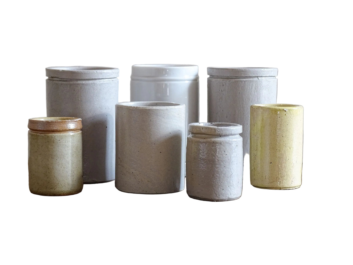 A set of seven small French vintage stoneware pots. This collection of pottery jars would look amazing as part of a rustic French farmhouse style home. Display in your kitchen as part of your shelf decor.