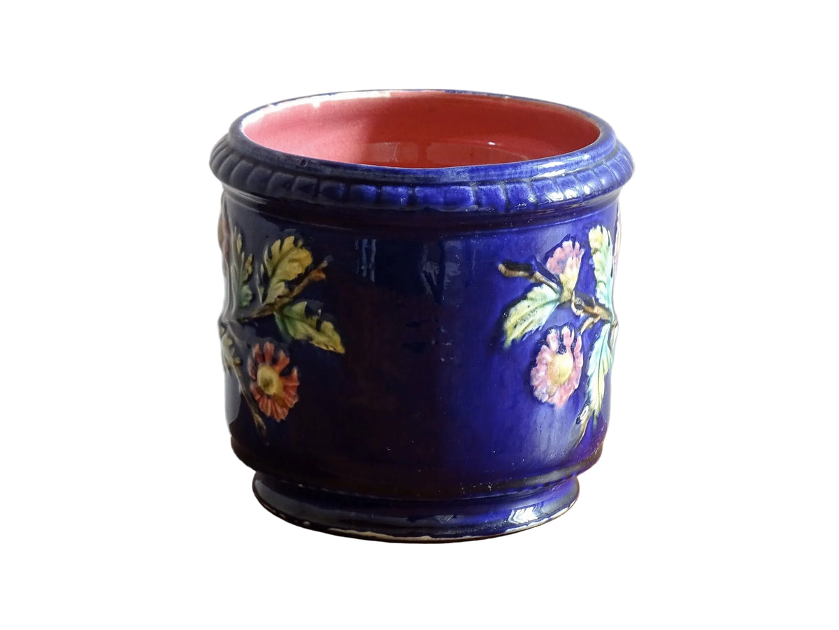 French antique barbotine ceramic planter. A lovely, cobalt blue cache-pot which is beautifully decorated with pink and yellow flowers along with green foliage.