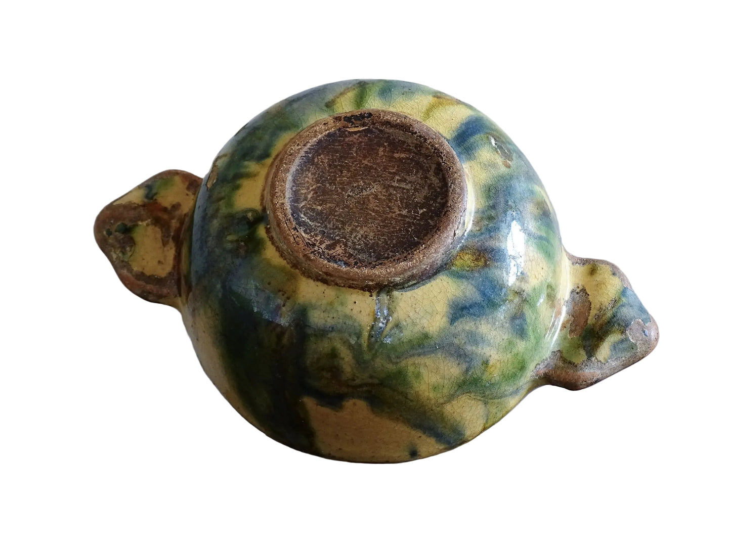 A French vintage ceramic souvenir bowl from Vichy, in the Auvergne region of France. Decorated with hand-applied sponged slip in yellow, green and blue tones. Mid 20th century, with a warm rustic glaze and visible age-related crazing.