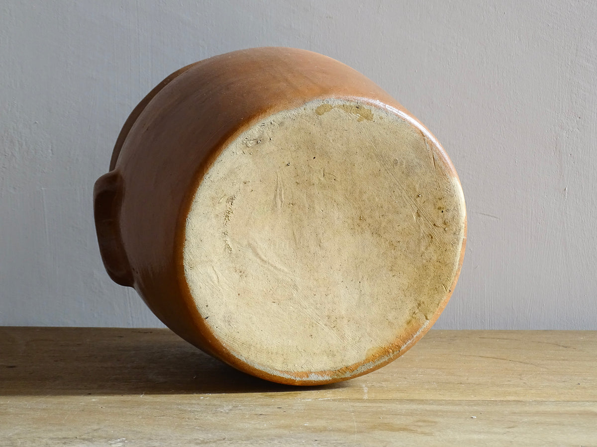 A French antique stoneware confit pot with a brown glaze. This salt glazed pottery cache pot dates to the early 20th century and would look amazing as part of a rustic French farmhouse style home.