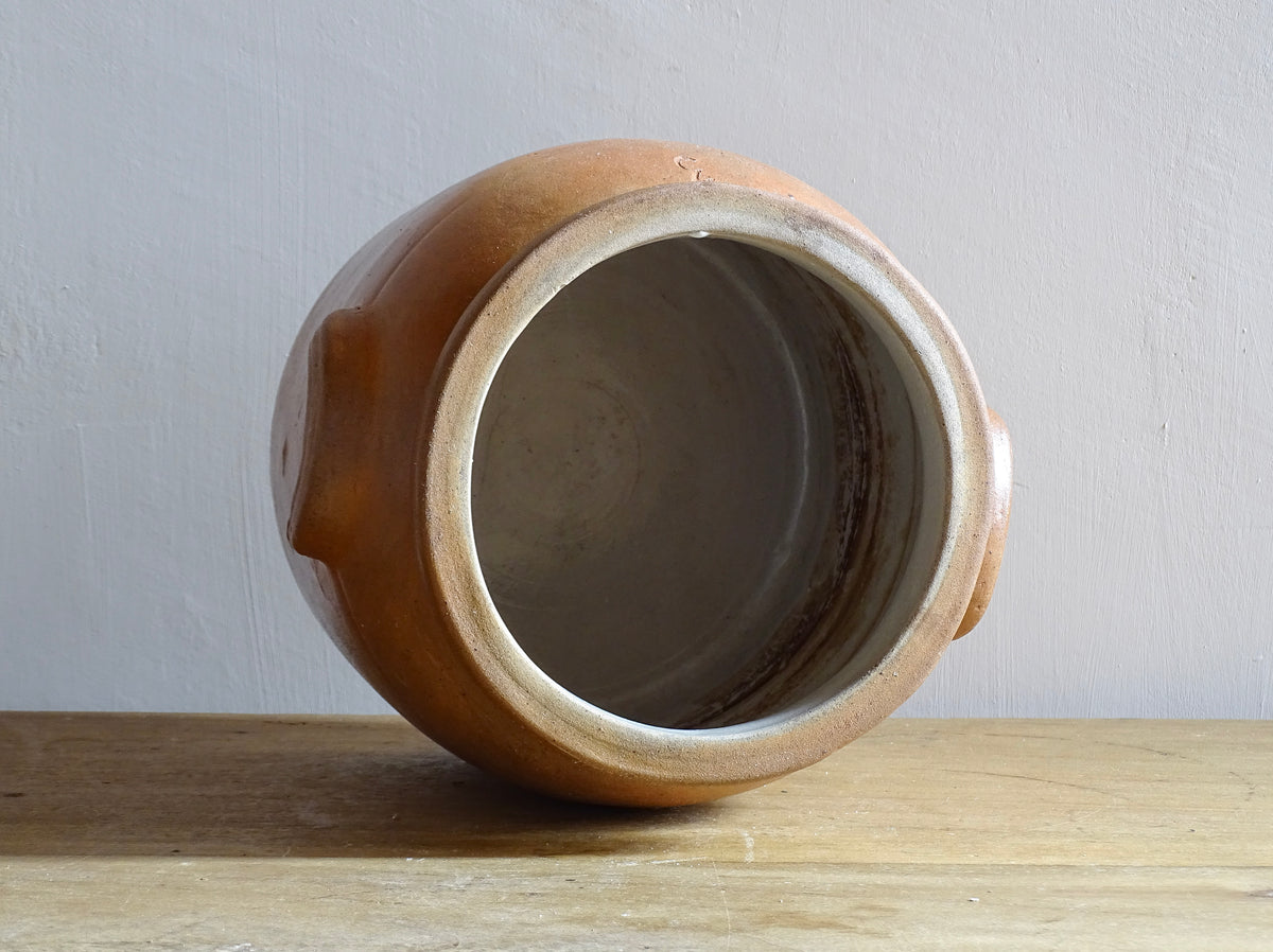 A French antique stoneware confit pot with a brown glaze. This salt glazed pottery cache pot dates to the early 20th century and would look amazing as part of a rustic French farmhouse style home.
