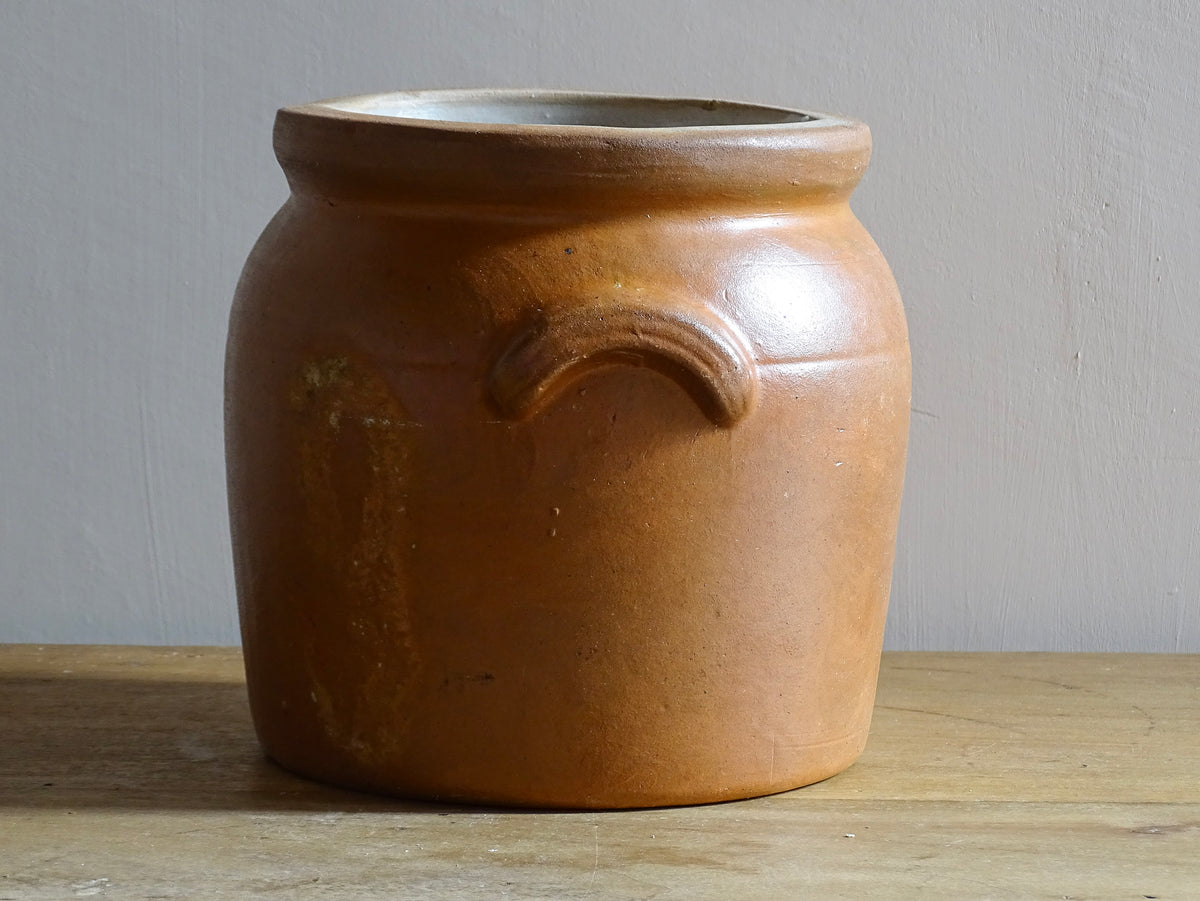 A French antique stoneware confit pot with a brown glaze. This salt glazed pottery cache pot dates to the early 20th century and would look amazing as part of a rustic French farmhouse style home.
