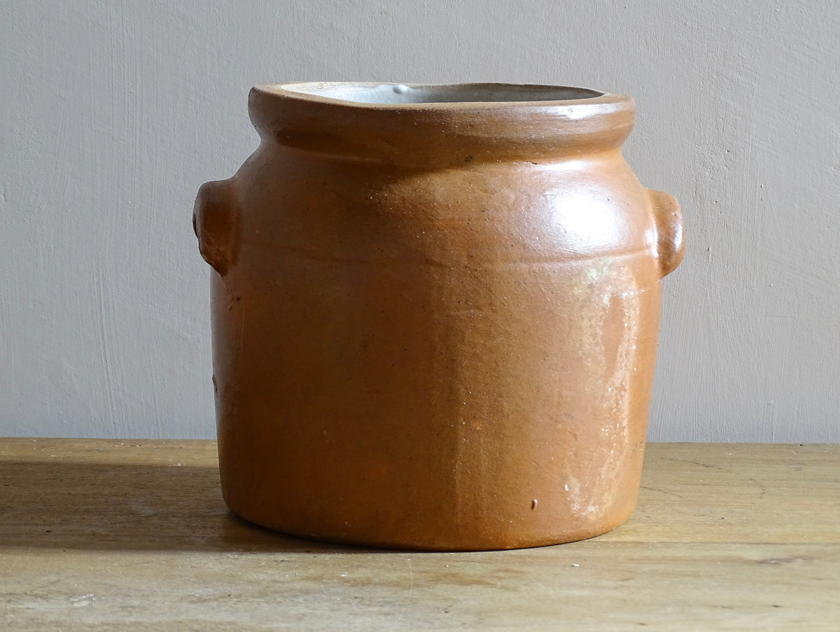 A French antique stoneware confit pot with a brown glaze. This salt glazed pottery cache pot dates to the early 20th century and would look amazing as part of a rustic French farmhouse style home.