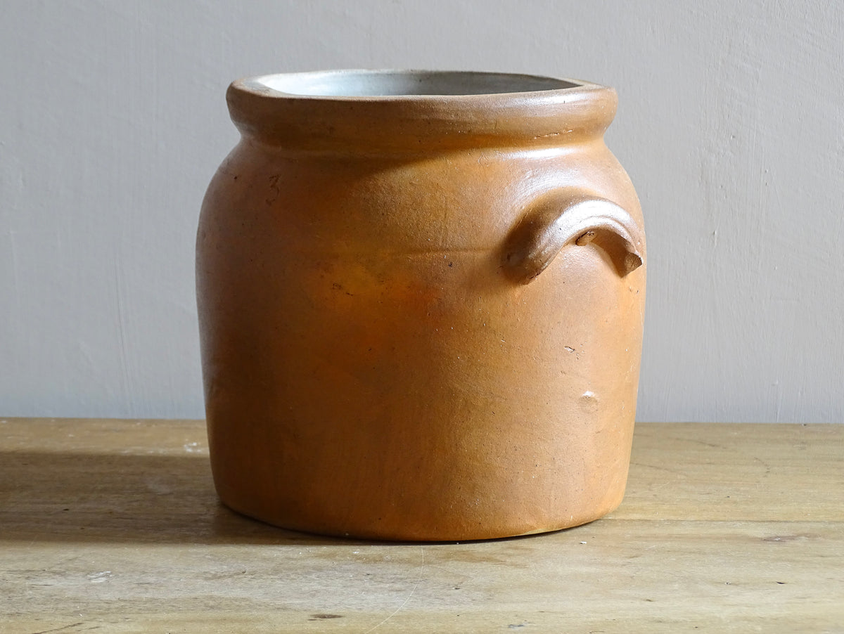 A French antique stoneware confit pot with a brown glaze. This salt glazed pottery cache pot dates to the early 20th century and would look amazing as part of a rustic French farmhouse style home.