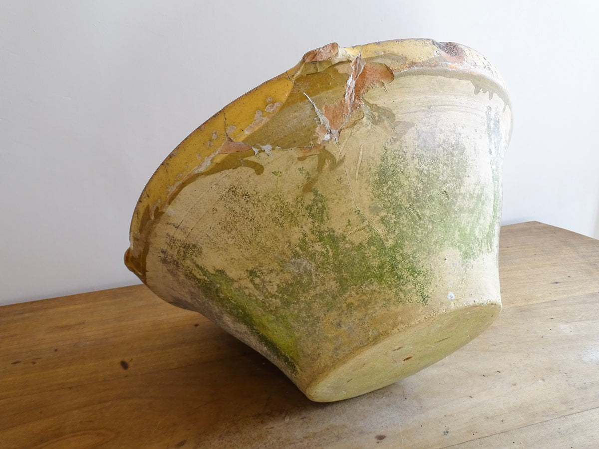 Large antique French confit bowl or gressalle with a yellow glaze to the inside and an unglazed exterior. This terracotta bowl, also known as a tian bowl, has a beautiful patina and originates from South West France.