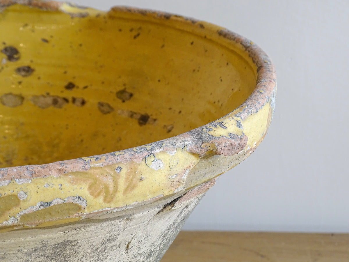 Large antique French confit bowl or gressalle with a yellow glaze to the inside and an unglazed exterior. This terracotta bowl, also known as a tian bowl, has a beautiful patina and originates from South West France.