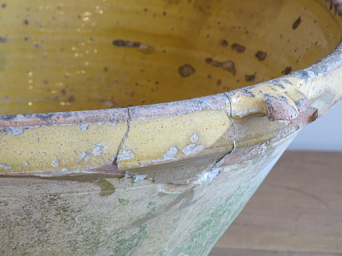 Large antique French confit bowl or gressalle with a yellow glaze to the inside and an unglazed exterior. This terracotta bowl, also known as a tian bowl, has a beautiful patina and originates from South West France.