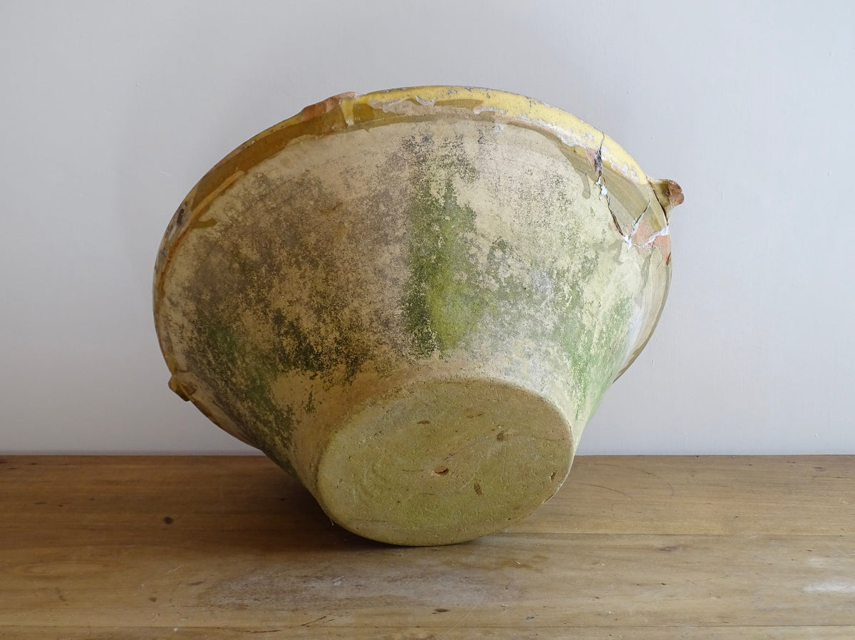 Large antique French confit bowl or gressalle with a yellow glaze to the inside and an unglazed exterior. This terracotta bowl, also known as a tian bowl, has a beautiful patina and originates from South West France.