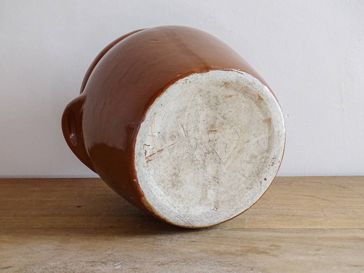 French antique stoneware preserving jar with a brown glaze. This pottery cache pot dates to the early 20th century and has a high gloss glaze.
