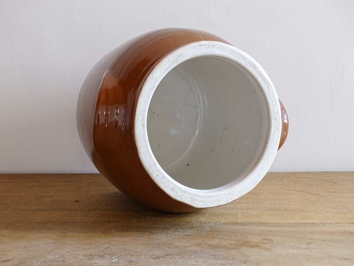 French antique stoneware preserving jar with a brown glaze. This pottery cache pot dates to the early 20th century and has a high gloss glaze.