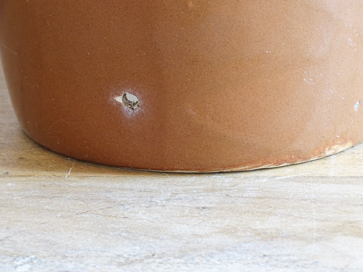 French antique stoneware preserving jar with a brown glaze. This pottery cache pot dates to the early 20th century and has a high gloss glaze.