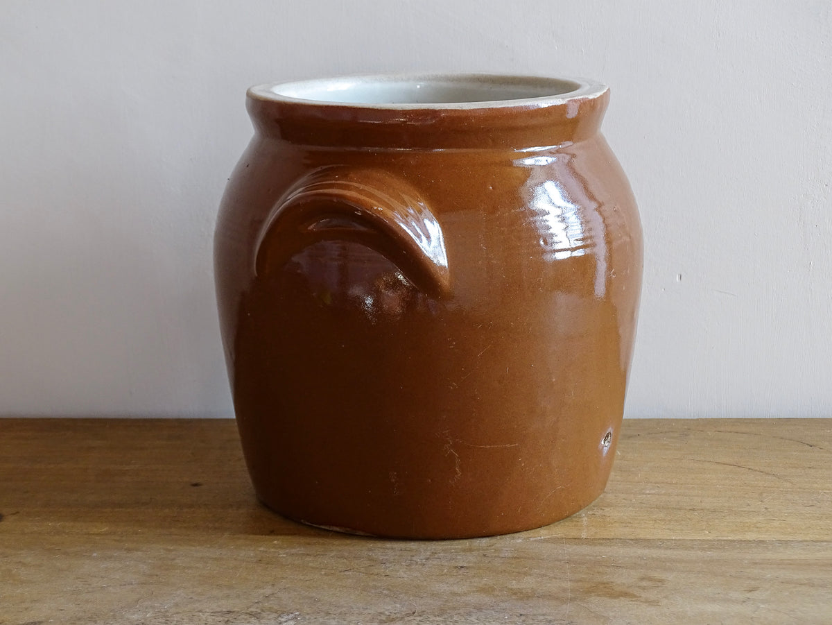 French antique stoneware preserving jar with a brown glaze. This pottery cache pot dates to the early 20th century and has a high gloss glaze.