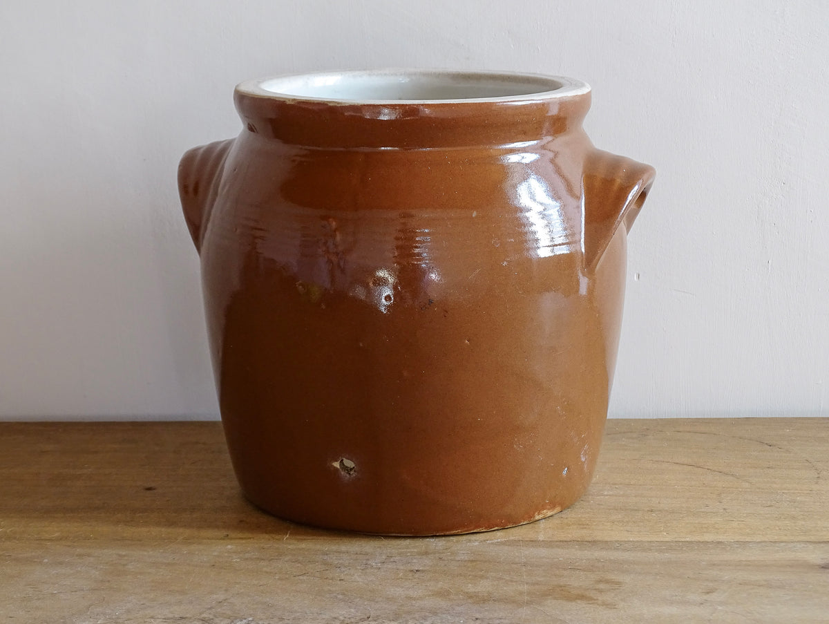 French antique stoneware preserving jar with a brown glaze. This pottery cache pot dates to the early 20th century and has a high gloss glaze.