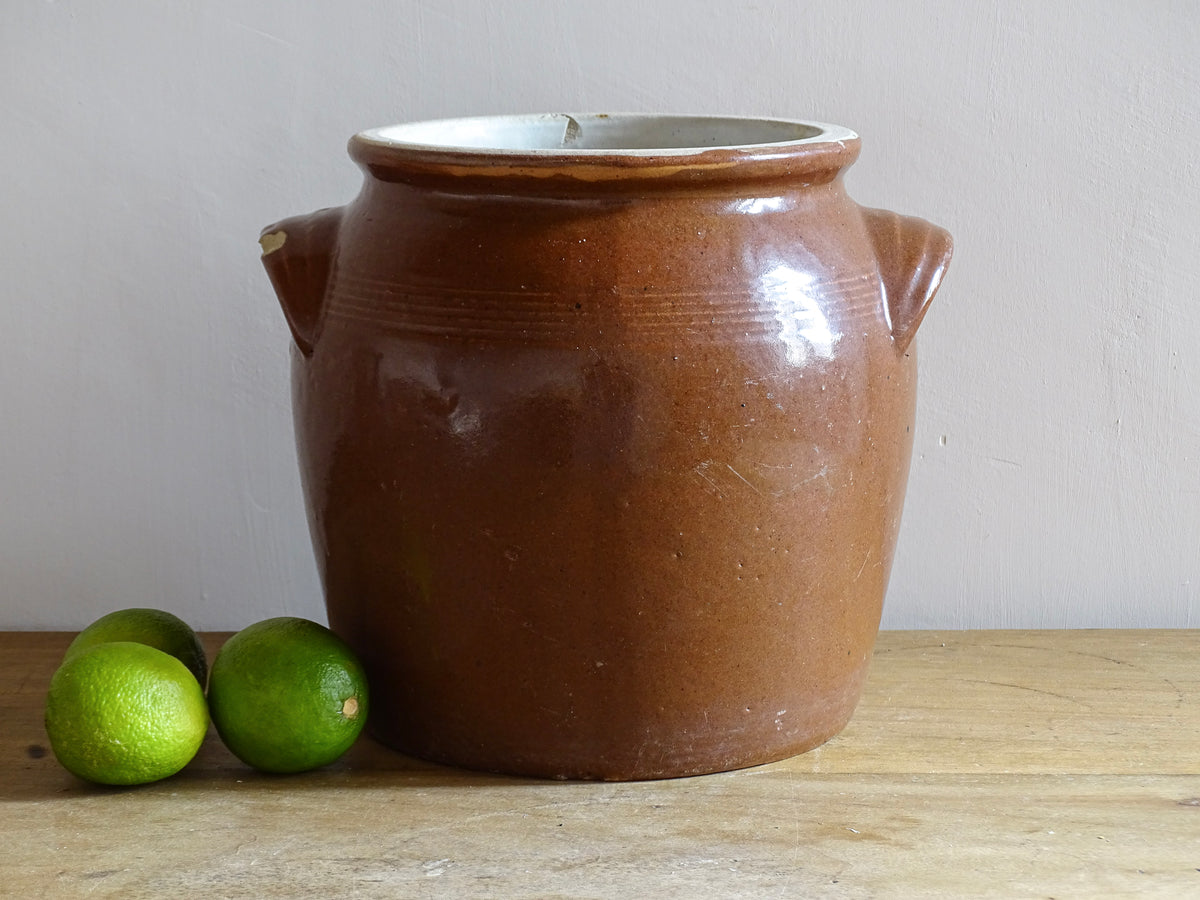 French antique stoneware preserving jar with a brown glaze. This pottery cache pot dates to the early 20th century and has a high gloss glaze.