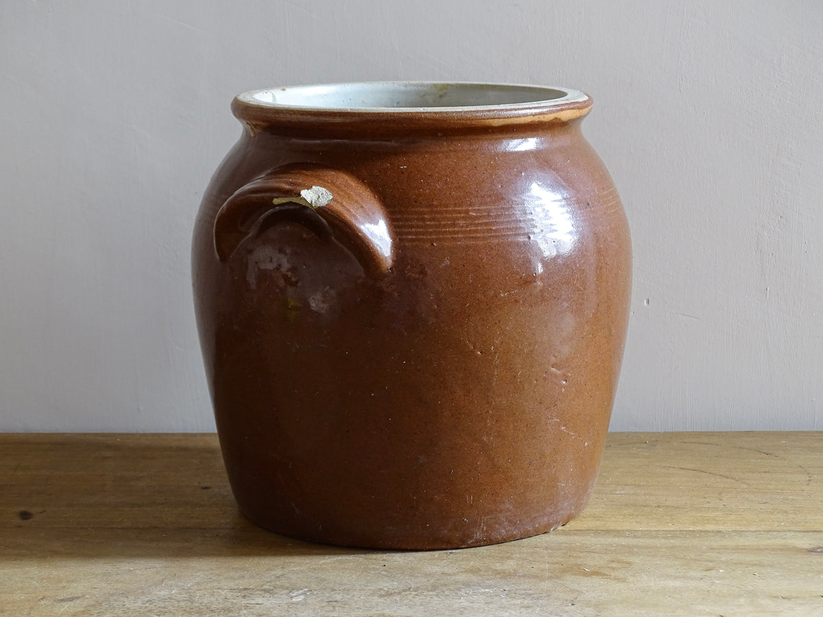 French antique stoneware preserving jar with a brown glaze. This pottery cache pot dates to the early 20th century and has a high gloss glaze.