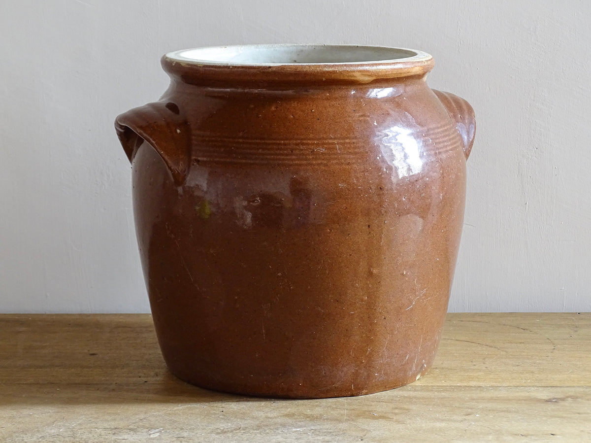 French antique stoneware preserving jar with a brown glaze. This pottery cache pot dates to the early 20th century and has a high gloss glaze.