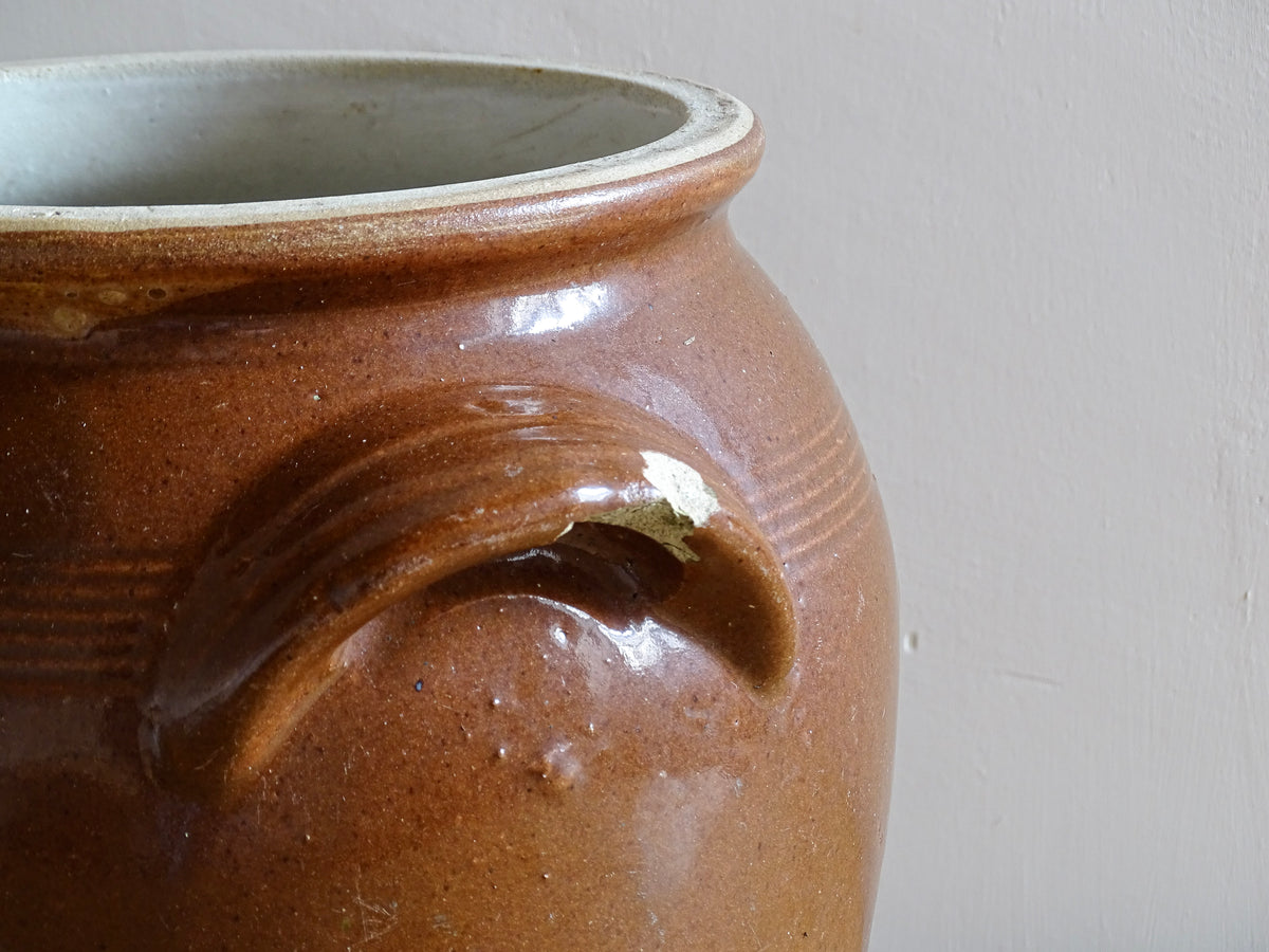 French antique stoneware preserving jar with a brown glaze. This pottery cache pot dates to the early 20th century and has a high gloss glaze.