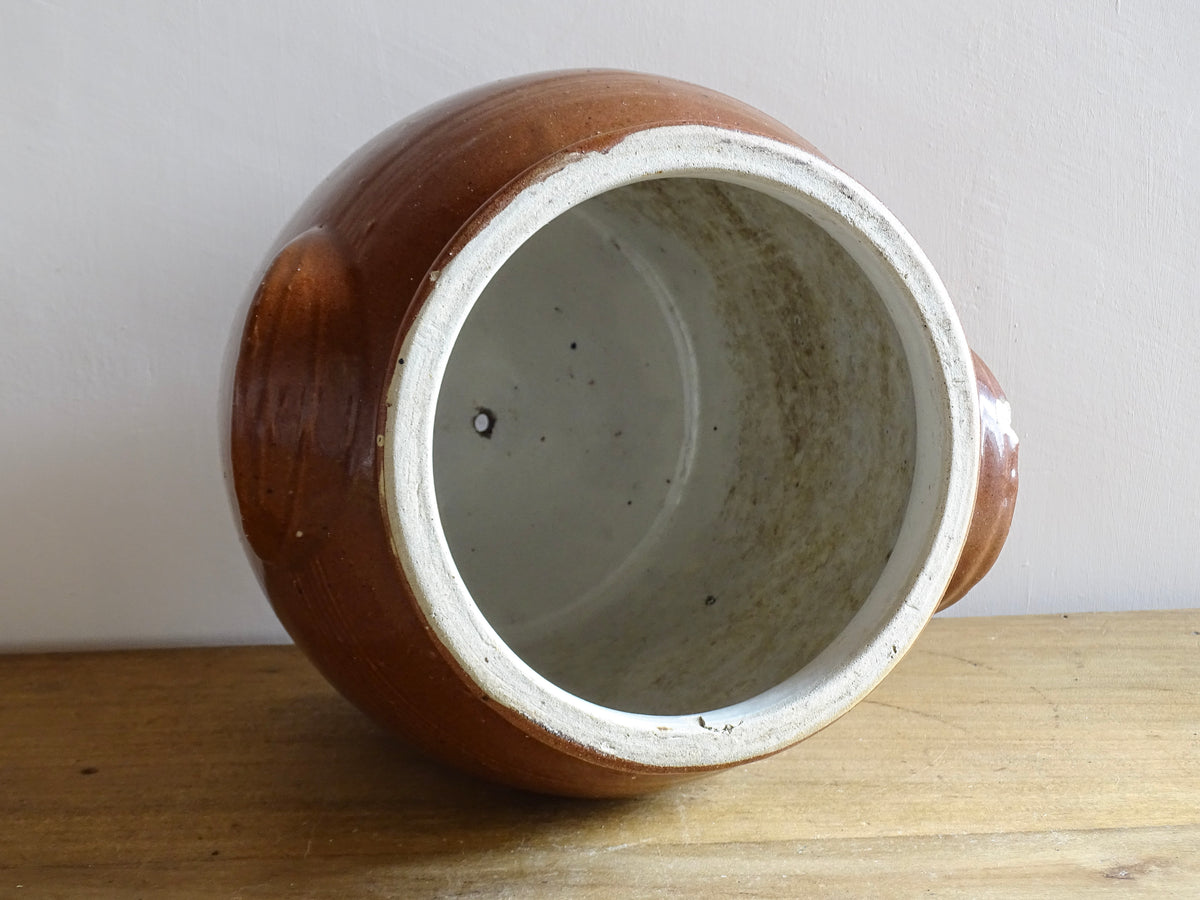 French antique stoneware preserving jar with a brown glaze. This pottery cache pot dates to the early 20th century and has a high gloss glaze.