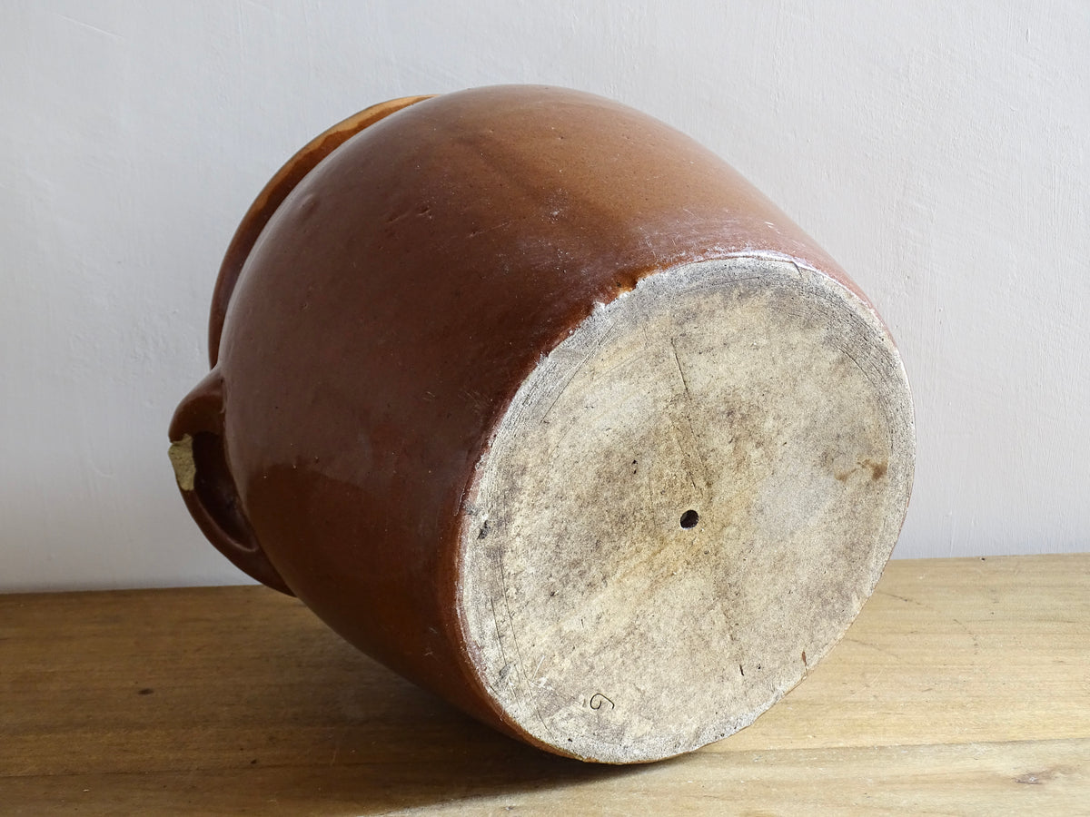 French antique stoneware preserving jar with a brown glaze. This pottery cache pot dates to the early 20th century and has a high gloss glaze.