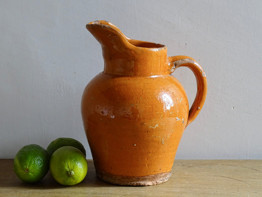 French antique terracotta cruche with orange glaze and rustic finish