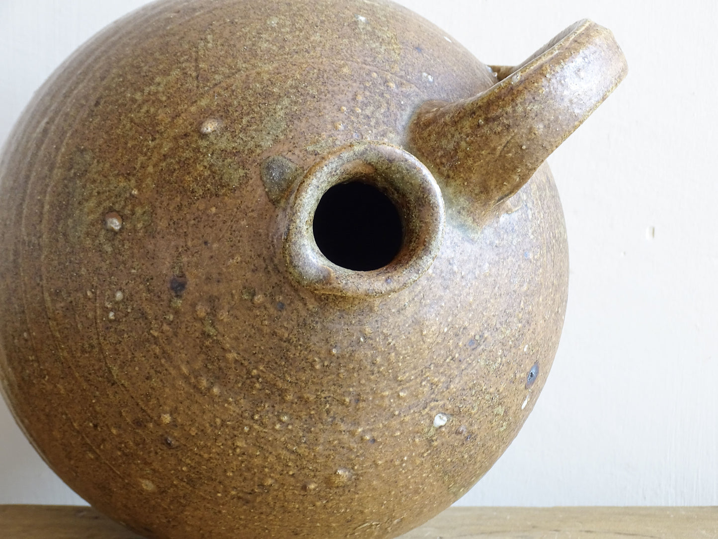 A rustic French antique pottery water or wine pitcher. It has gorgeous warm brown tones. This ceramic jug dates from the nineteenth century