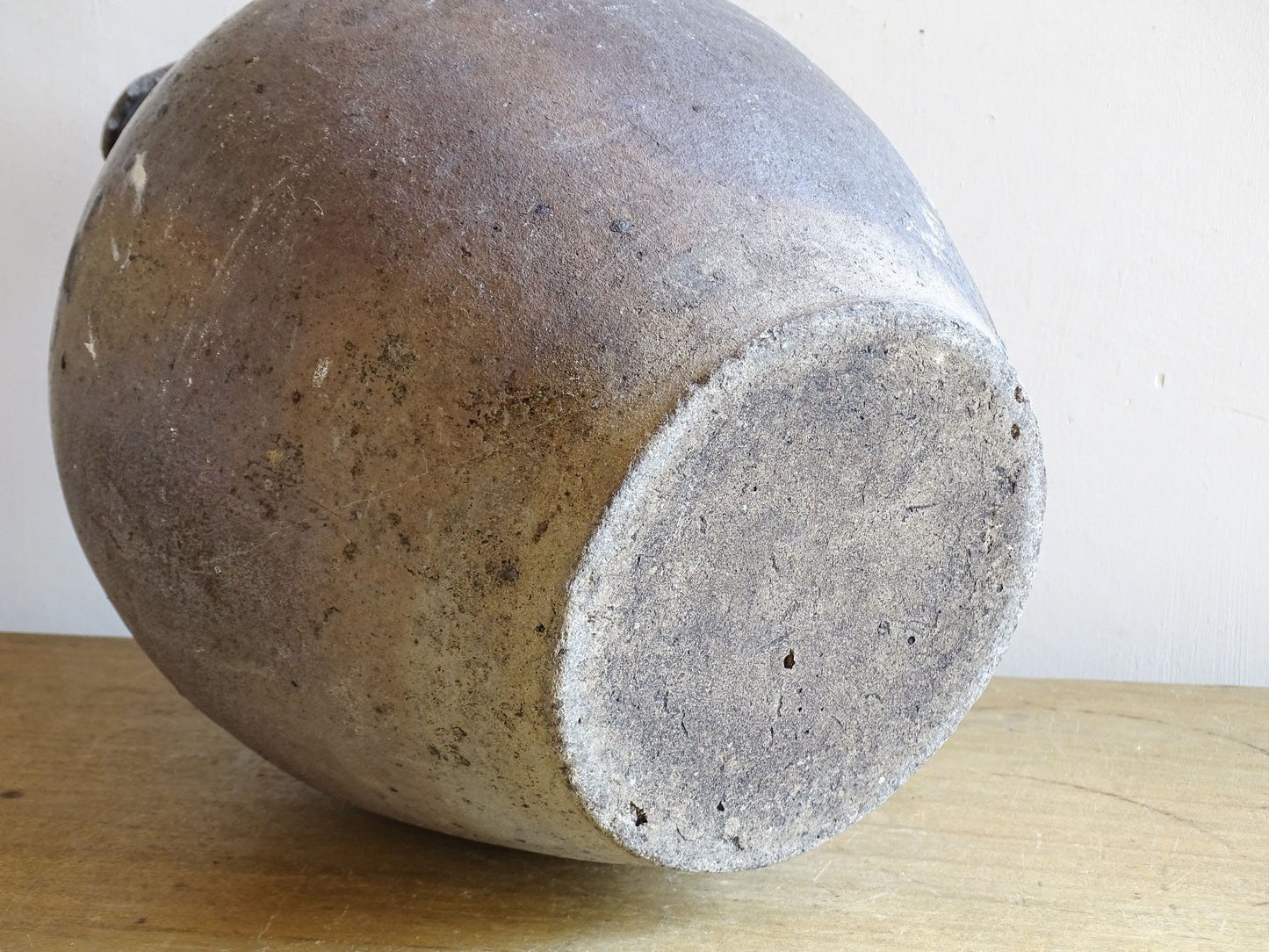 Rustic antique earthenware jug with loop handles and aged glaze patina