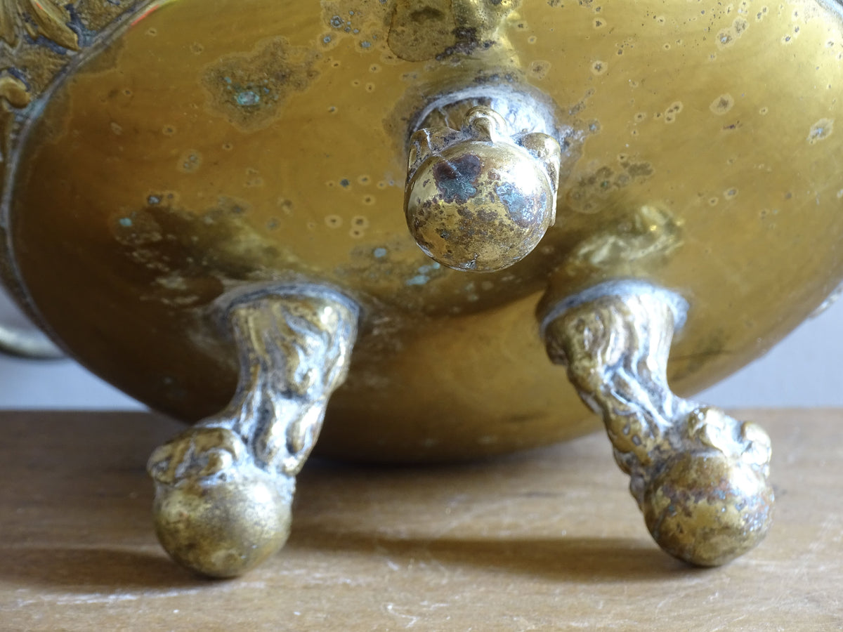 Highly ornate French antique brass jardinière with ball and claw feet. Dating to the late nineteenth century. It is such a decorative piece with richly detailed floral and scrolling relief.