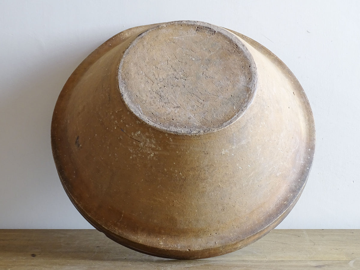 French vintage ceramic mixing bowl from Pérignac, Charente, stamped by a regional pottery workshop. This vintage terracotta bowl has a pale glazed interior and pouring lip.