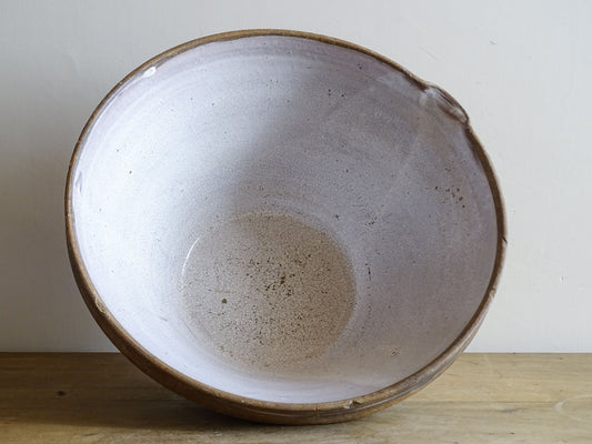 French vintage ceramic mixing bowl from Pérignac, Charente, stamped by a regional pottery workshop. This vintage terracotta bowl has a pale glazed interior and pouring lip.