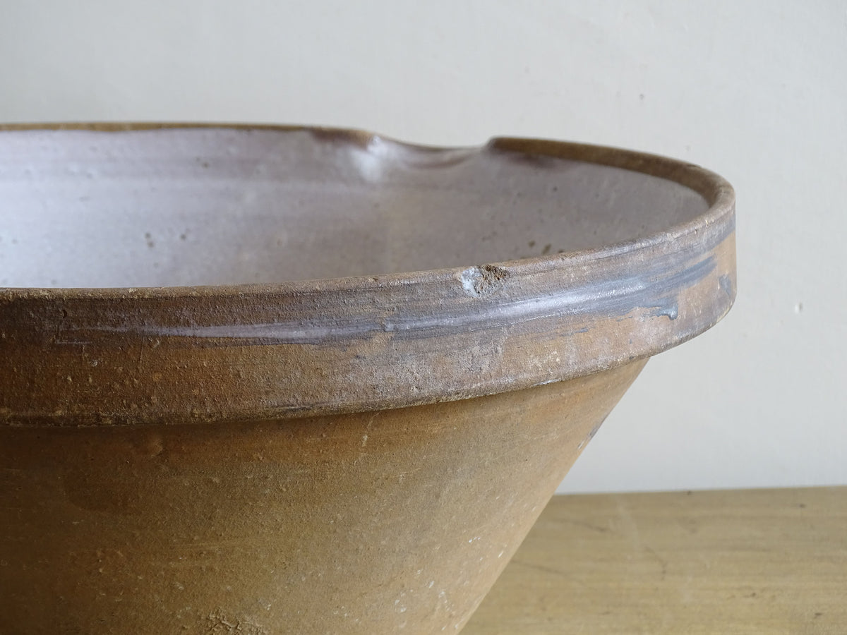 French vintage ceramic mixing bowl from Pérignac, Charente, stamped by a regional pottery workshop. This vintage terracotta bowl has a pale glazed interior and pouring lip.