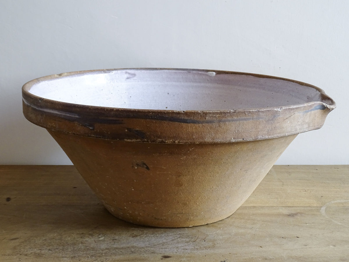 French vintage ceramic mixing bowl from Pérignac, Charente, stamped by a regional pottery workshop. This vintage terracotta bowl has a pale glazed interior and pouring lip.