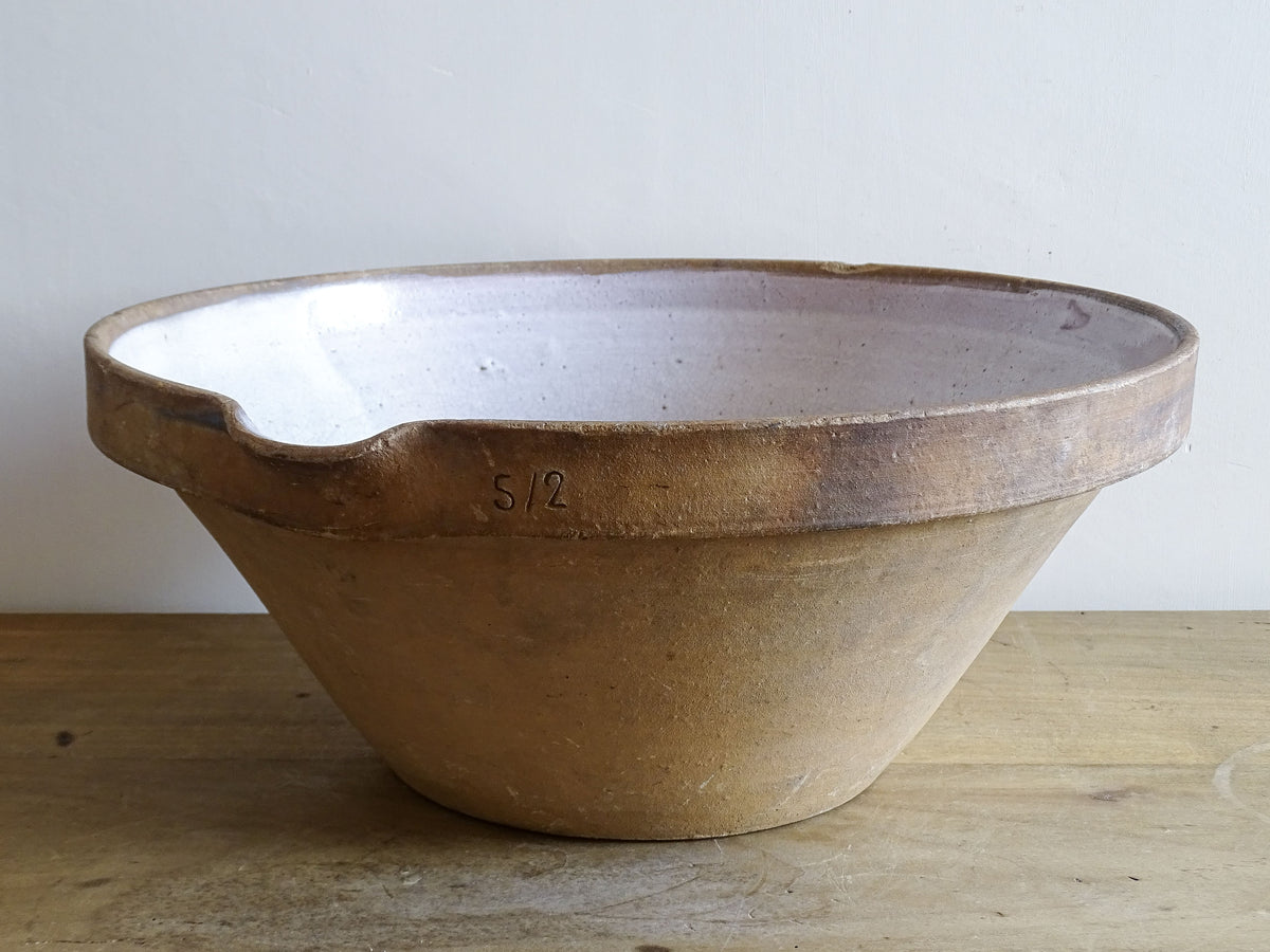 French vintage ceramic mixing bowl from Pérignac, Charente, stamped by a regional pottery workshop. This vintage terracotta bowl has a pale glazed interior and pouring lip.