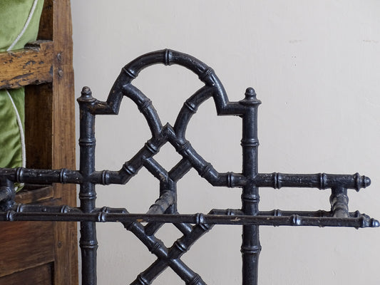 A striking French antique umbrella stand in cast iron, featuring an intricate bamboo-form design with geometric lattice detailing and original drip trays. Dating to the late 19th century
