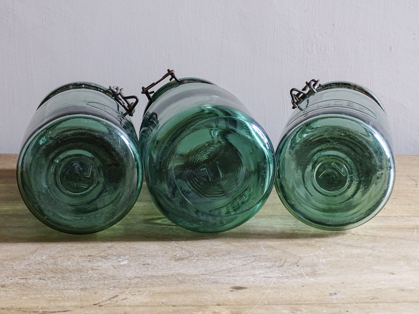 Close up of vintage French SOLIDEX glass jar lids and aged wire fastenings