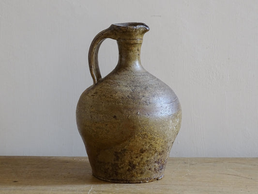 Rustic French antique earthenware cruche with rounded body and handle