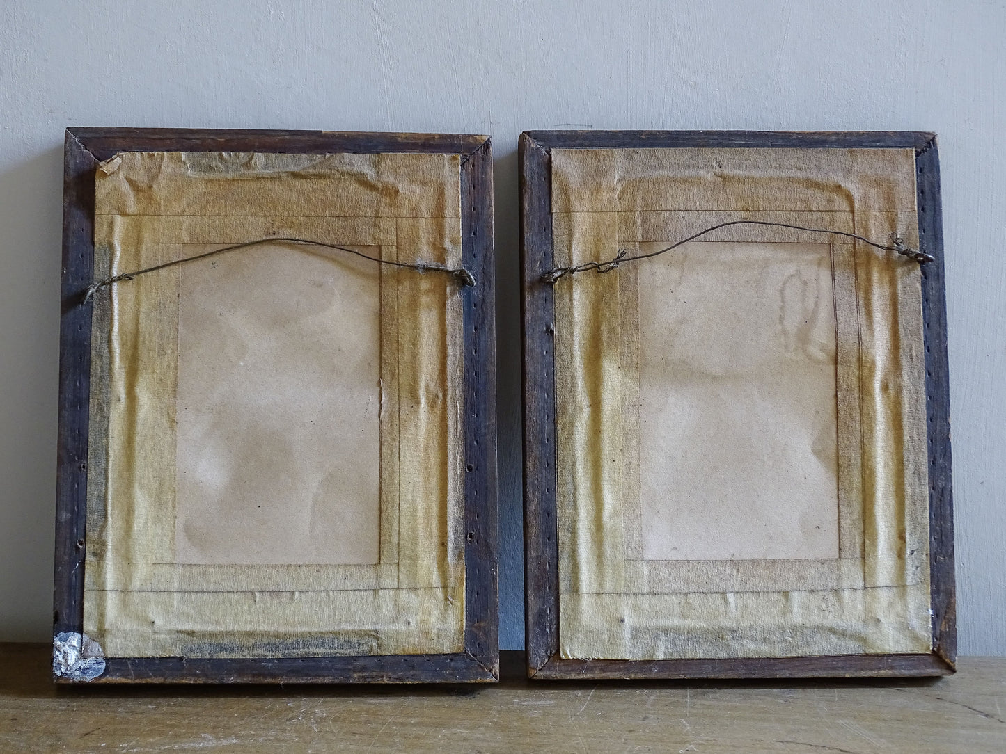 Antique bird wall decor with aged paper and decorative moulded frames